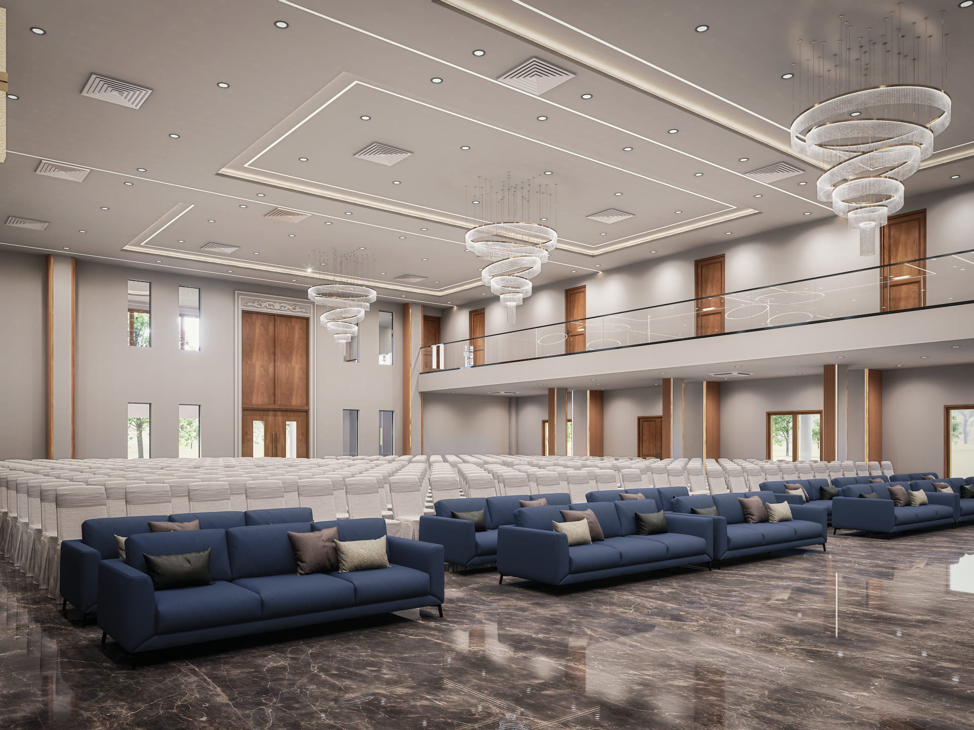 Luxury event hall interior with elegant chandeliers, marble flooring, blue lounge seating, and spacious auditorium layout.